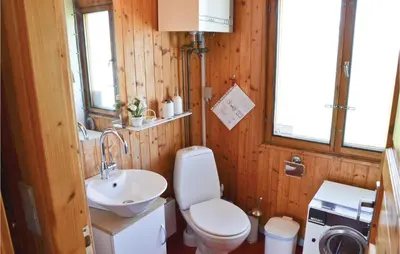 a bathroom with a toilet and a sink at Holiday Home Svenstibakkevej Frøstrup in Frøstrup