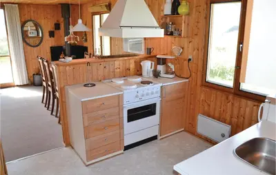 a kitchen with a white stove and a sink at Holiday Home Svenstibakkevej Frøstrup in Frøstrup