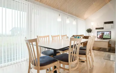 a dining room with a table and chairs at Holiday Home Kronvildtvej Brovst in Brovst