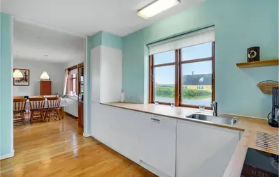 a kitchen with a sink and a counter top at Holiday Home Strandvejen Harboøre X in Harboør