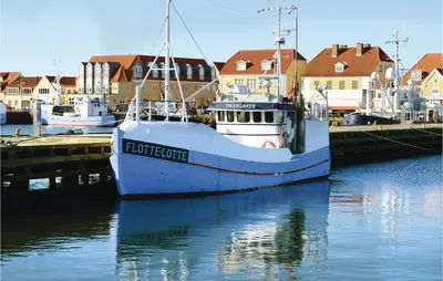 a boat is docked at a dock in the water at Holiday Home Viktoriavej Harboøre Ii in Harboør
