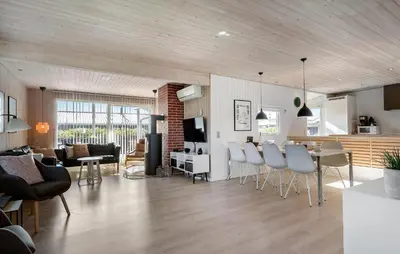 a living room with a kitchen and a dining room at Holiday Home Vejlby Klit Harboøre V in Harboør