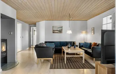 a living room with a couch and a table at Gorgeous Home In Harboøre With Sauna in Harboør