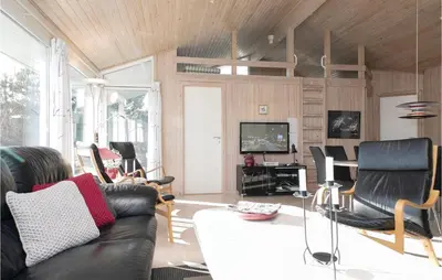 a living room with a black leather couch and chairs at Amazing Home In Saltum With Wifi in Saltum