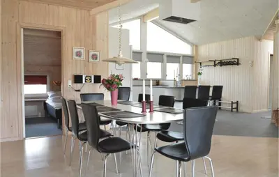 a dining room with a table and black chairs at Amazing Home In Saltum With Wifi in Saltum