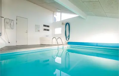 a bathroom with a swimming pool and a sink at Amazing Home In Saltum With Wifi in Saltum