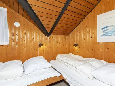 a room with two beds in a wooden room at 8 person holiday home in Løgstør-By Traum in Løgstør