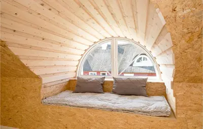 a small room with a window and a couch in front at Holiday Home Rødhus Klitvej in Pandrup