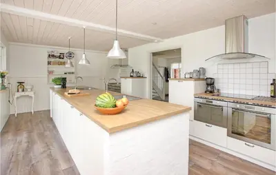 a kitchen with a bowl of fruit on a counter at Holiday Home Rødhus Klitvej in Pandrup