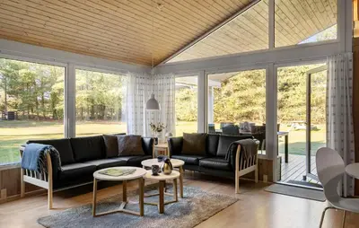 a living room with a couch and a table at 4 Bedroom Awesome Home In Saltum in Saltum