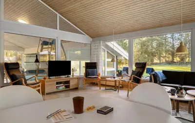 a living room with a couch and a television at 4 Bedroom Awesome Home In Saltum in Saltum