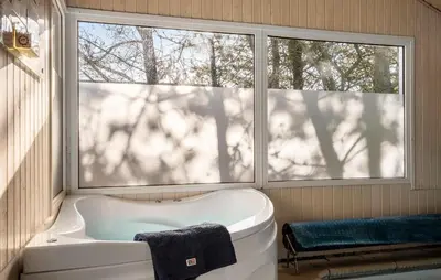 a bath tub in a room with a window at 4 Bedroom Awesome Home In Saltum in Saltum