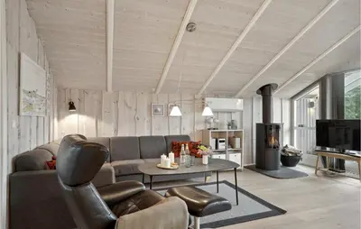 a living room with a couch and a table at Holiday Home Kristavej Løkken Xii in Løkken