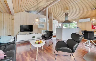 a living room with a table and chairs at Lovely Home In Saltum With Kitchen in Saltum