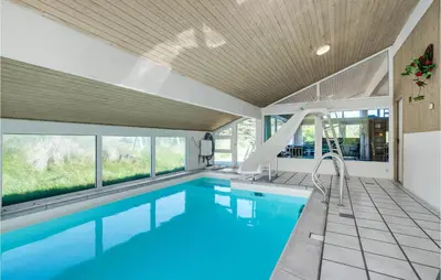 a swimming pool with a slide in a house at Awesome Home In Blokhus With Wifi in Blokhus