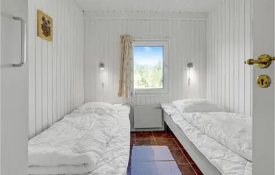 a white room with two beds and a window at Awesome Home In Blokhus With Wifi in Blokhus