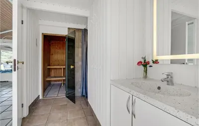 a white bathroom with a sink and a mirror at Awesome Home In Blokhus With Wifi in Blokhus