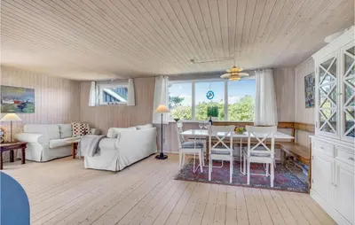 a living room with a table and chairs at Holiday Home Lyngvej Blokhus Iv in Blokhus