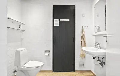 a bathroom with a toilet and a sink at Stunning Home In Blokhus With Sauna in Blokhus