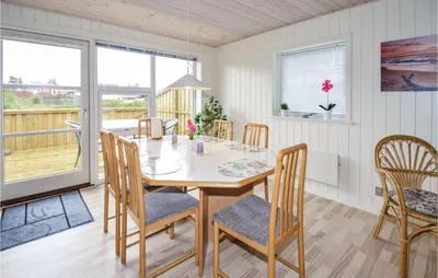a dining room with a table and chairs at Holiday Home Kristinesvej Blokhus X in Blokhus
