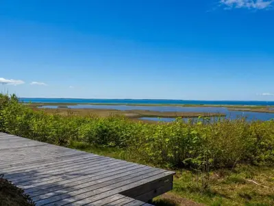 a wooden boardwalk next to a body of water at 6 person holiday home in Vinderup-By Traum in Vinderup