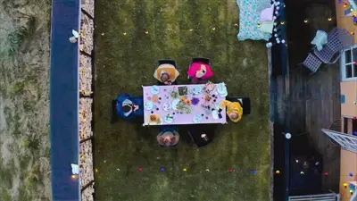 an overhead view of people sitting at a table in the grass at Viking Surf Cottage in Klitmøller