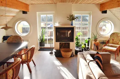 a living room with a couch and a tv at Viking Surf Cottage in Klitmøller