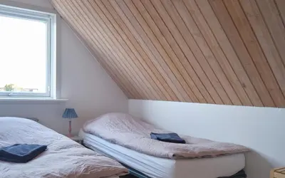 a bedroom with two twin beds and a window at Noah's Ark in Klitmøller