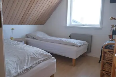 a bedroom with two beds and a window at Noah's Ark in Klitmøller