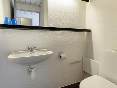a bathroom with a sink and a toilet and a mirror at 4 person holiday home in Brovst-By Traum in Brovst