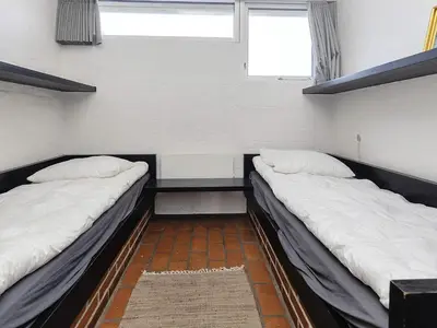 two beds in a small room with a window at 4 person holiday home in Brovst-By Traum in Brovst