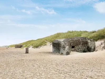 a stone building sitting on a sandy beach at 6 person holiday home in Brovst-By Traum in Brovst