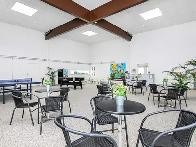 a room with tables and chairs and a piano at 6 person holiday home in Brovst-By Traum in Brovst
