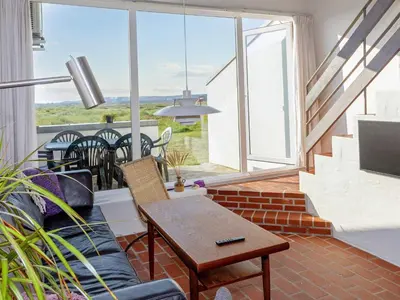 a living room with a couch and a table at 6 person holiday home in Brovst-By Traum in Brovst