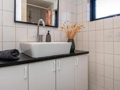 a bathroom with a sink and a mirror at 6 person holiday home in Løgstør-By Traum in Løgsted