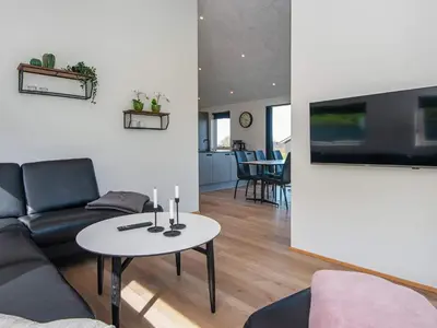 a living room with a couch and a table at 6 person holiday home in Lemvig-By Traum in Lemvig