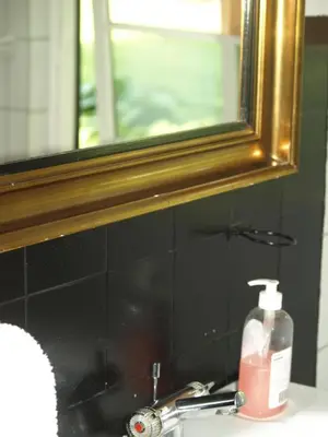 a bathroom sink with a mirror and a bottle of soap at Fadeburet på Skibstedgaard in Tvolm