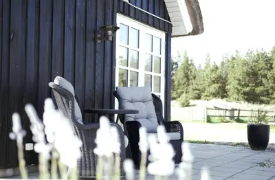 two chairs and a table on a patio at Lildgaard in Frøstrup