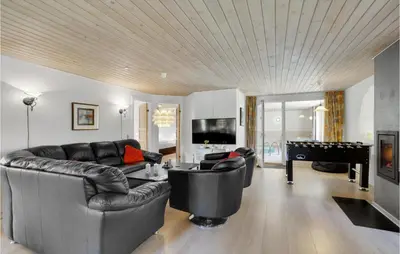 a living room with a couch and a pool table at Awesome Home In Løgstør With Sauna in Løgstør