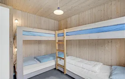 two bunk beds in a cabin with a ceiling at Holiday Home Illeris Xi in Farsø