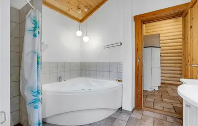 a bathroom with a large tub and a shower at Holiday Home Ramshule Farsø Xii in Farsø