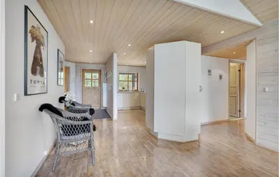 a living room with white walls and a wooden ceiling at Holiday Home Benediktesvej Løgstør X in Løgstør