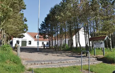 a white building with a sign in front of it at Holiday Home Kjeldhøj Farsø Xi in Farsø