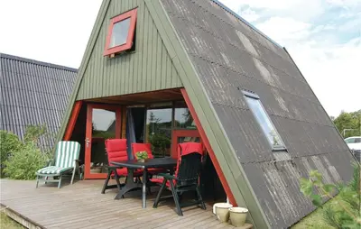 a dome house with a table and chairs on a deck at Holiday Home Golfsvinget in Farsø