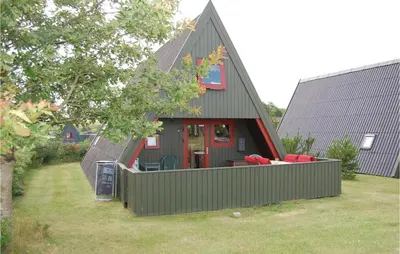 a house with a green fence in front of it at Holiday Home Golfsvinget in Farsø