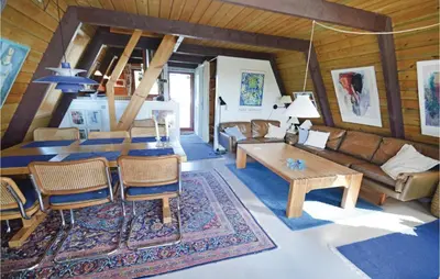 a living room with a couch and a table at Holiday Home Golfsvinget in Farsø