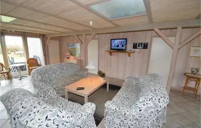 a living room with two couches and a table at Holiday Home Illeris Farsø Ix in Farsø