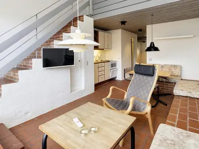 a living room with a couch and a table at 6 person holiday home in Brovst-By Traum in Brovst