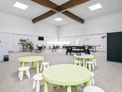 a classroom with tables and chairs and a chalkboard at 6 person holiday home in Brovst-By Traum in Brovst