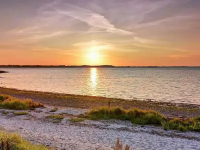 a sunset over a body of water at 6 person holiday home in Farsø-By Traum in Farsø